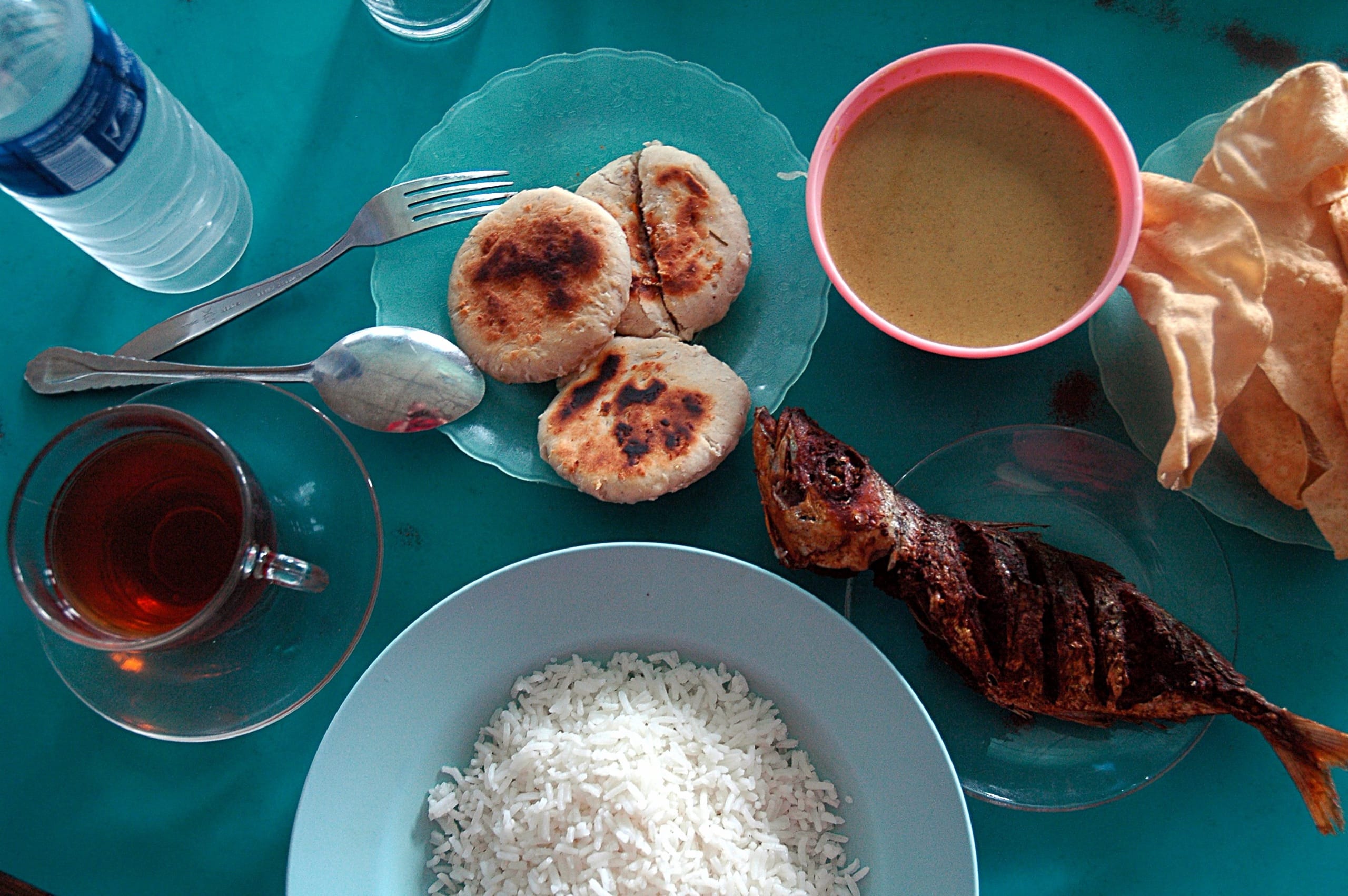 A Maldivian meal of masroshi pastries, fish curry, grilled fish, rice and black tea