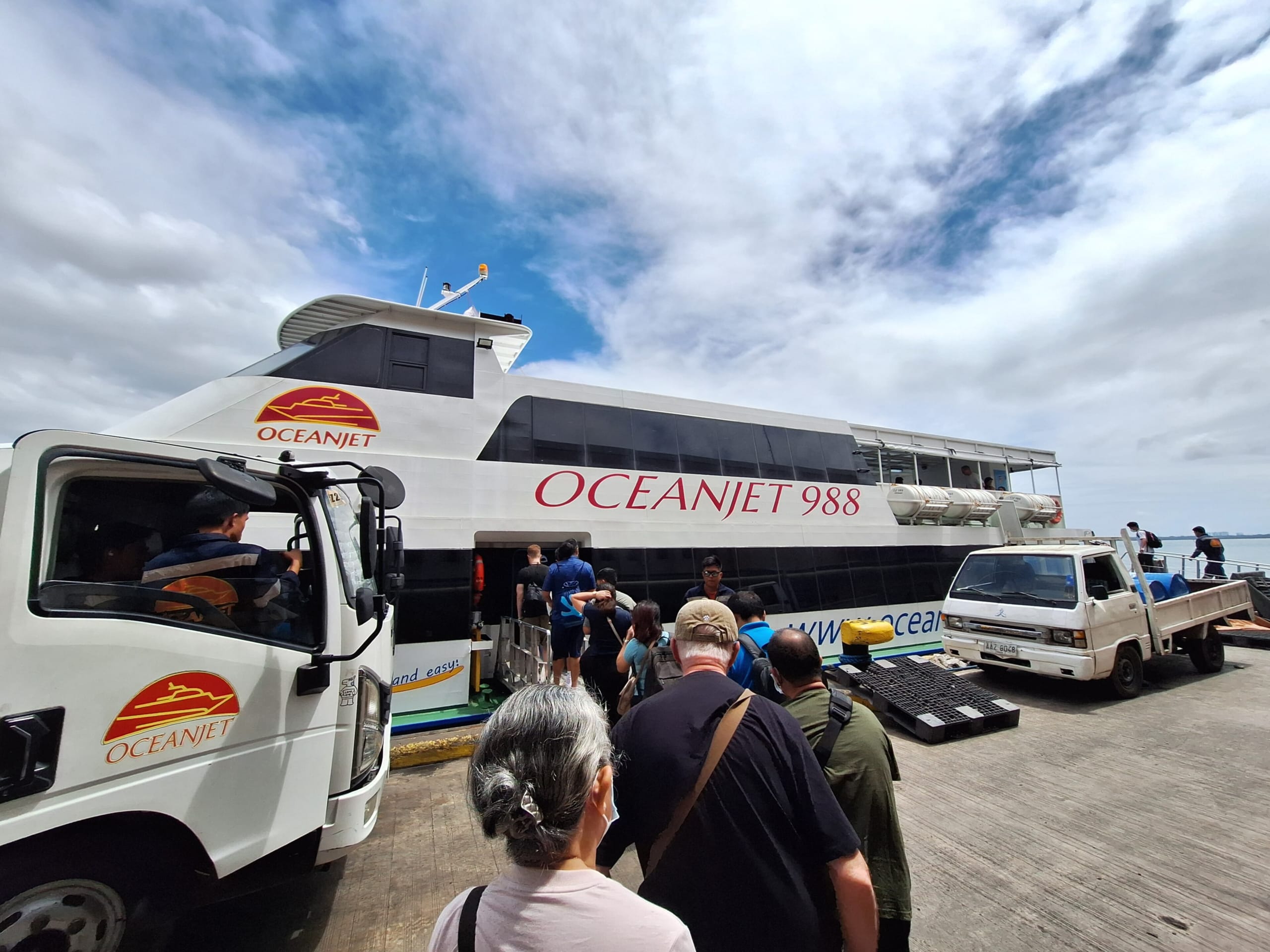 Passengers in line on the pier to board the OceanJet 988 fast ferry at Cebu Pier 1