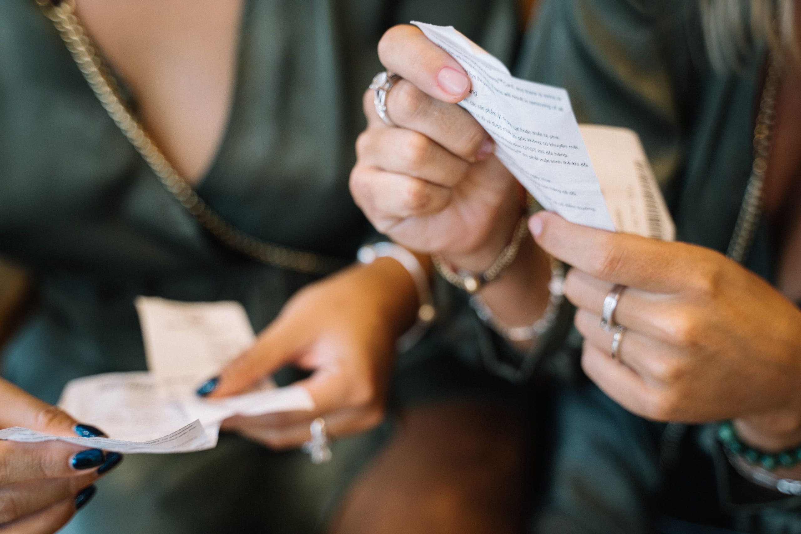 Two people reading a printed receipt over a table