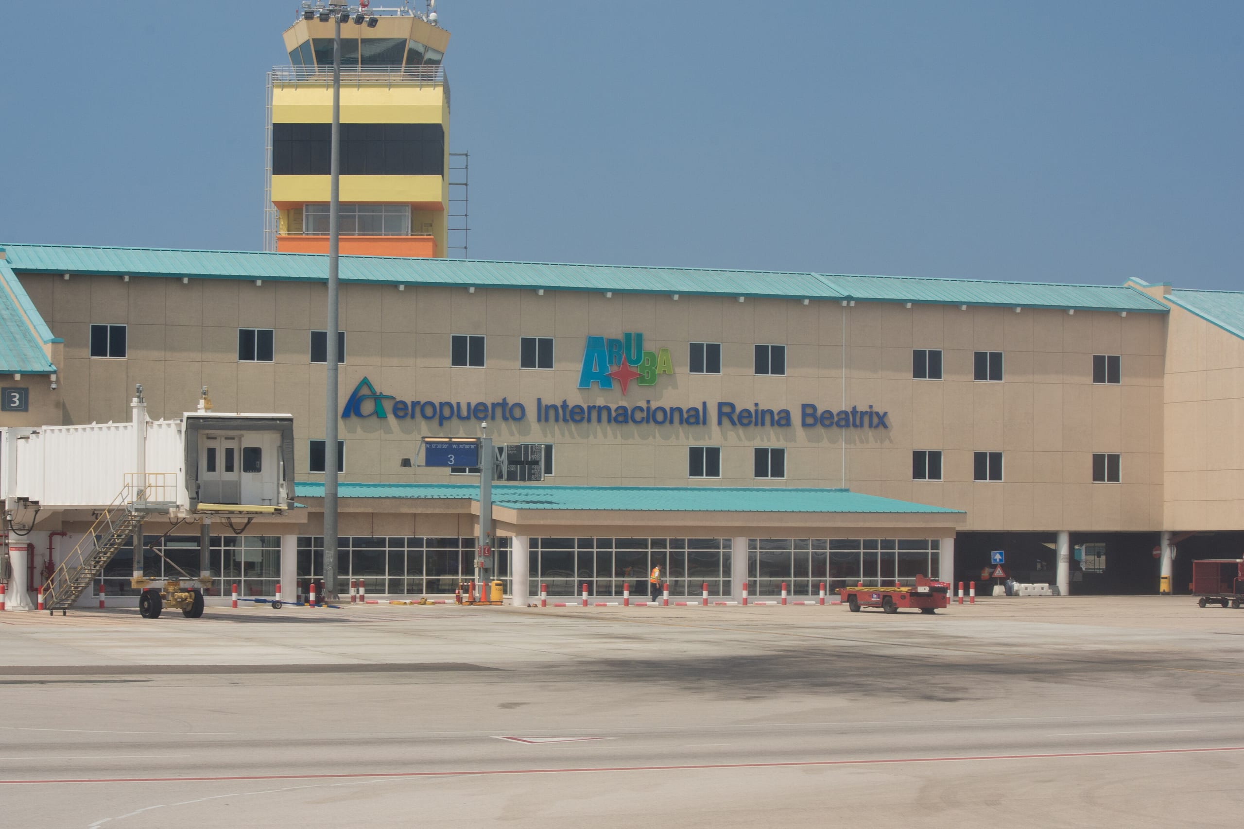 The terminal building at Queen Beatrix International Airport with its control tower behind